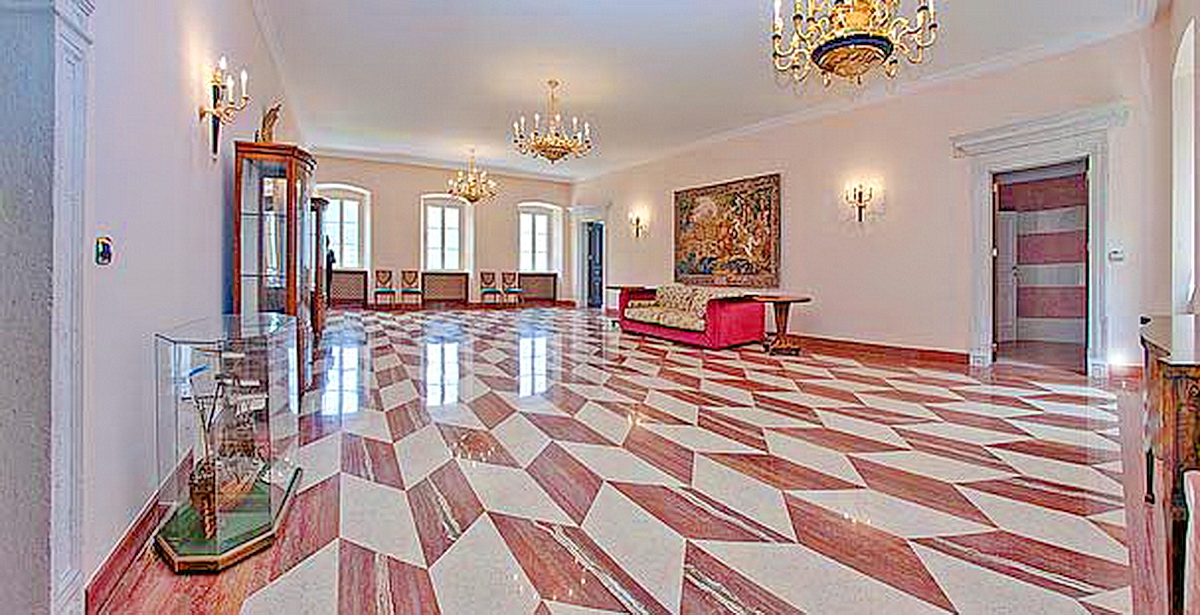 Luxurious living room with marble floor and chandeliers in a villa in Dobrota, Montenegro: classic interior with antiques.