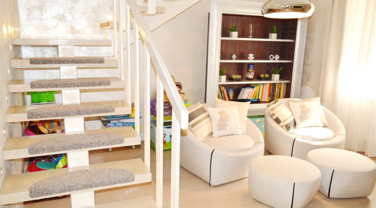 Living room with staircase and armchairs in a villa in Tivat, Montenegro: interior with modern finishes and decor.