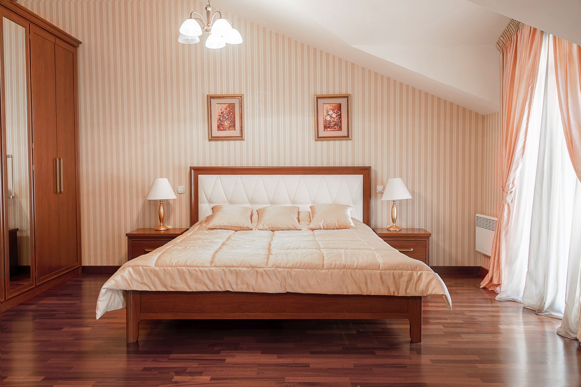 Cozy bedroom with a double bed in a townhouse, Lastva, Montenegro: wooden furniture and a bright interior.