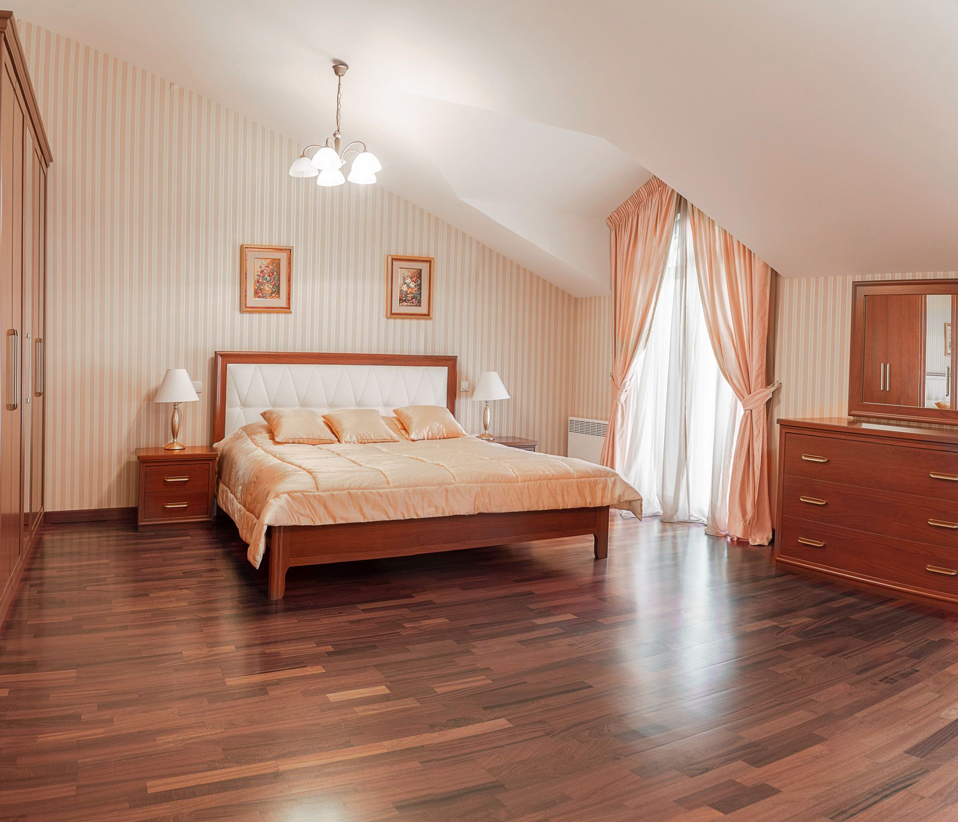 Cozy bedroom in a townhouse in Lastva, Montenegro: double bed, wooden furniture, parquet flooring, and skylight windows.