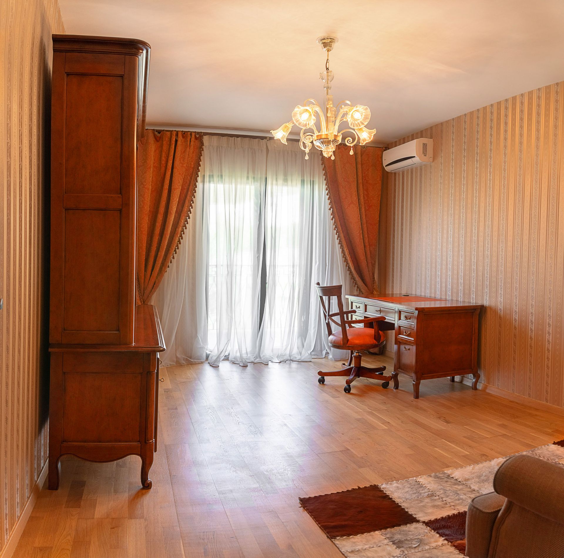 Classic study in a townhouse, Lastva, Montenegro: wooden furniture, parquet flooring, chandelier, and access to the terrace.