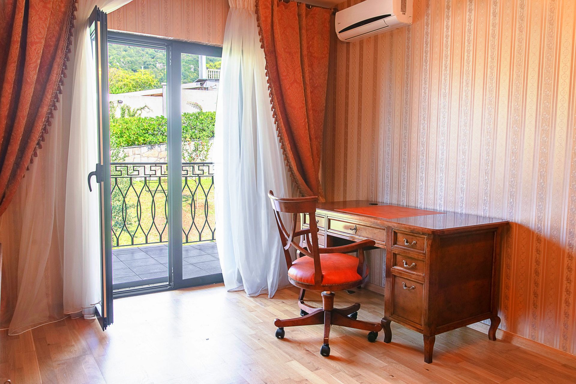 Study with an antique desk and access to the terrace in a townhouse, Lastva, Montenegro.