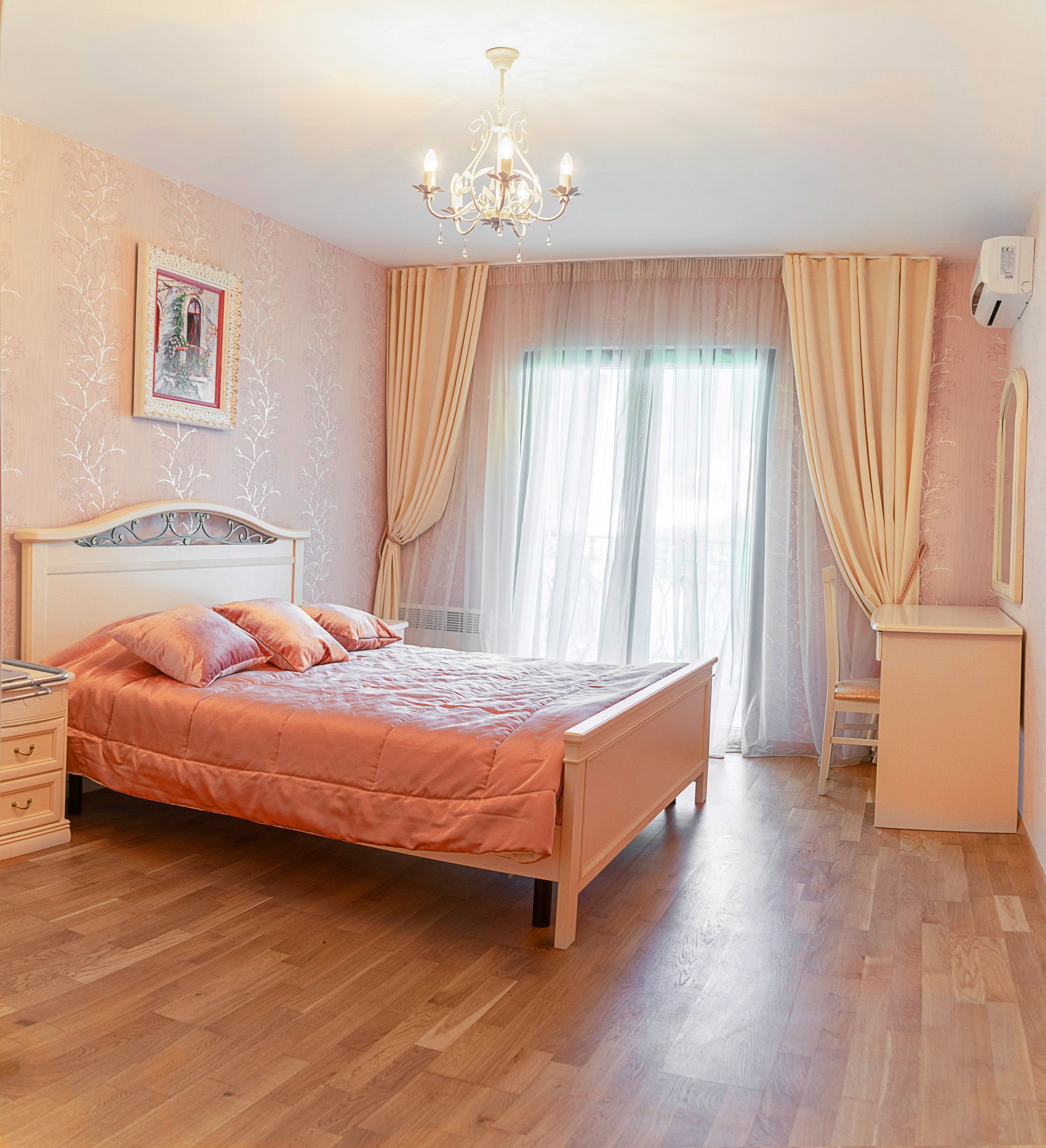 Cozy bedroom with a double bed in a townhouse, Lastva, Montenegro: light furniture, parquet flooring, and access to the balcony.