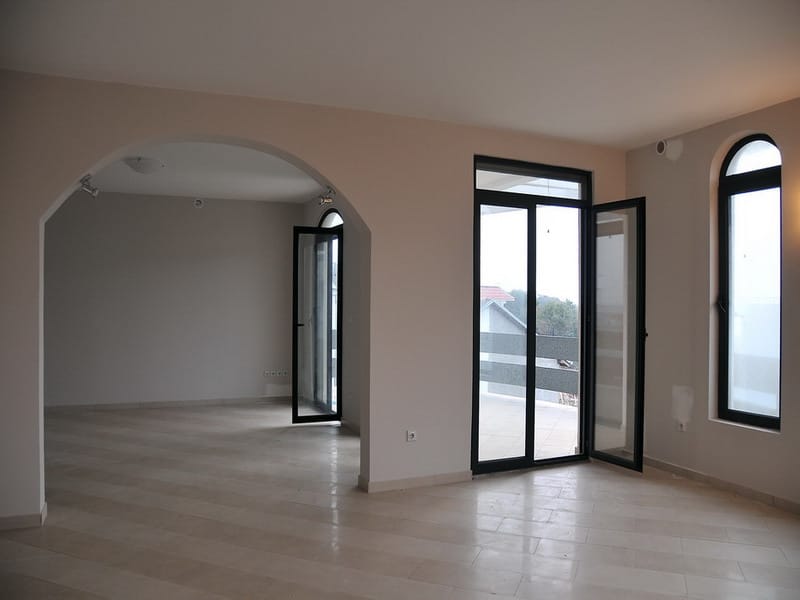 Bright living room with an arched opening and panoramic windows in a house for sale, Utjeha, Montenegro.