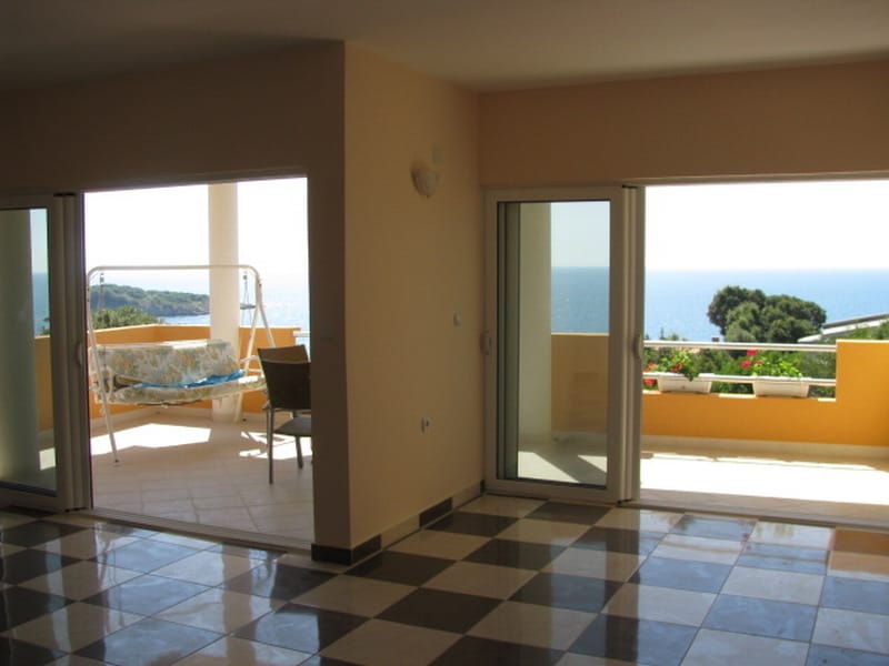 Living room with panoramic windows and access to a terrace with sea views in a house, Utjeha, Montenegro.