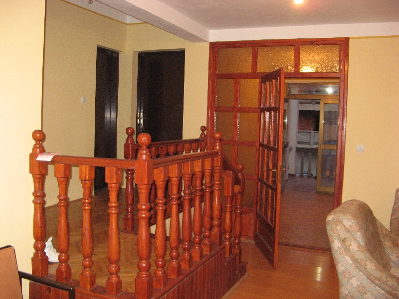 Living room with a wooden staircase and interior doors in a house for sale, Shushan, Montenegro.