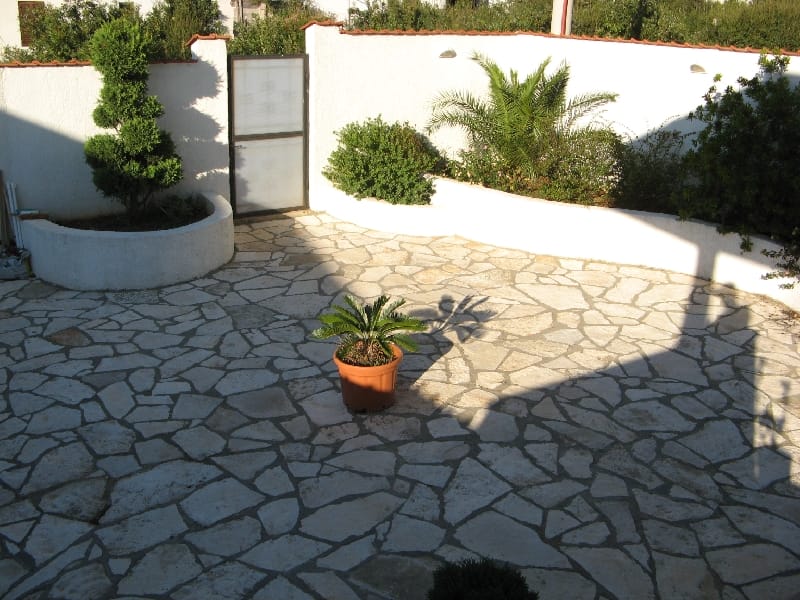 Cozy courtyard with stone paving and landscaping by the house in Utjeha, Montenegro.