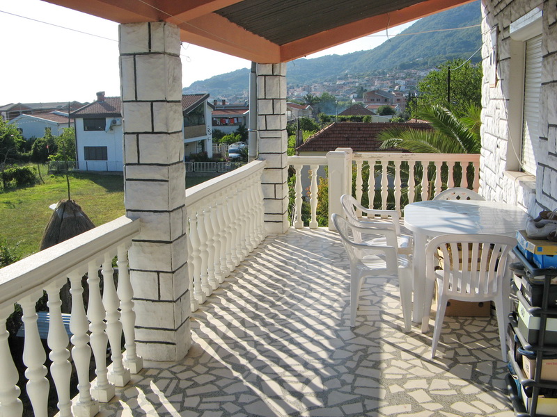 Spacious terrace with plastic furniture and mountain views in a house, Bar, Montenegro.