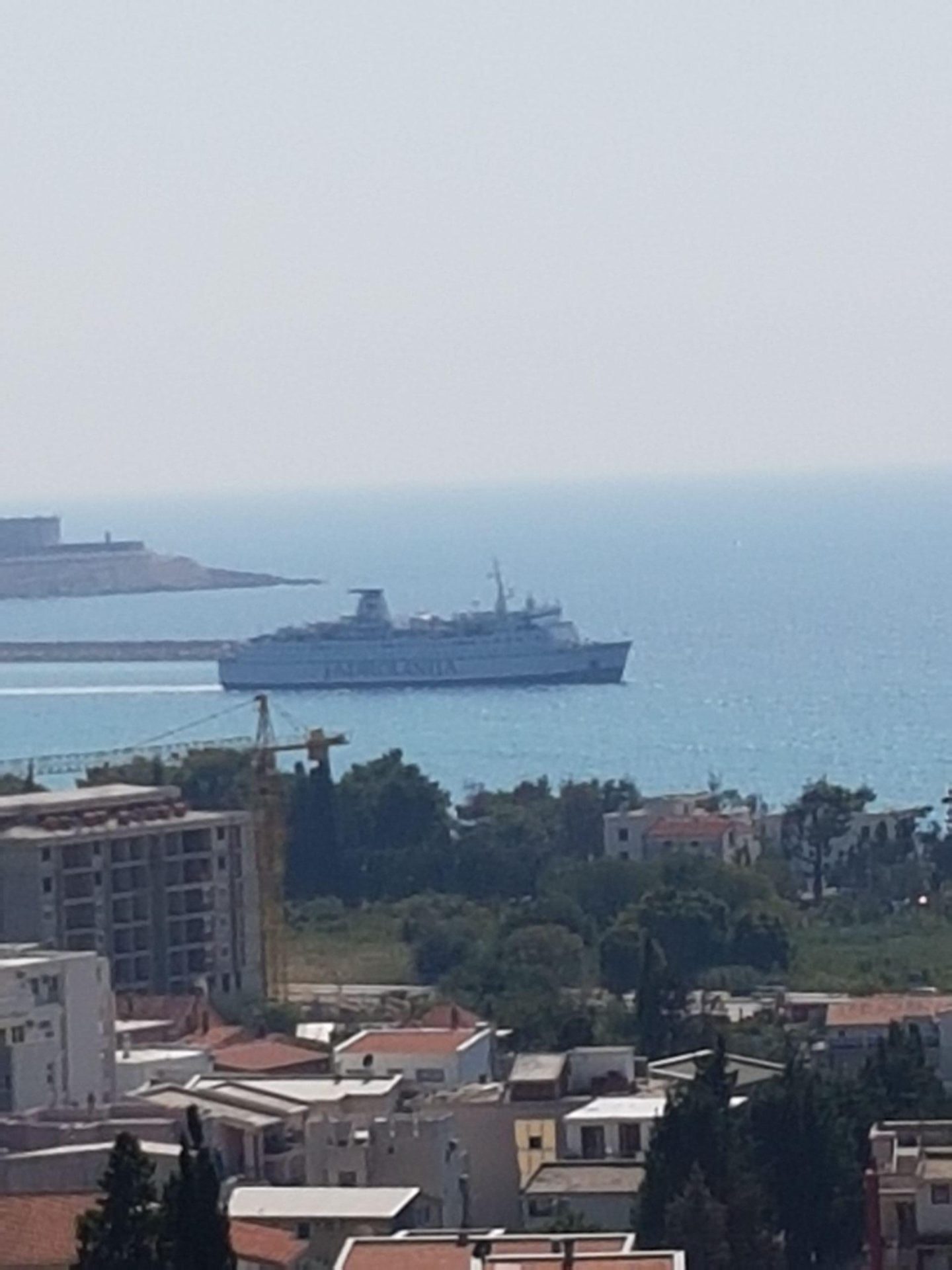 Panoramic sea view and a cruise ship from a house in Shushan, Montenegro, overlooking the city development.