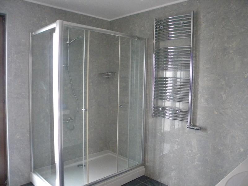 Modern bathroom with a shower cabin and towel warmer in a villa in Herceg Novi, Montenegro.