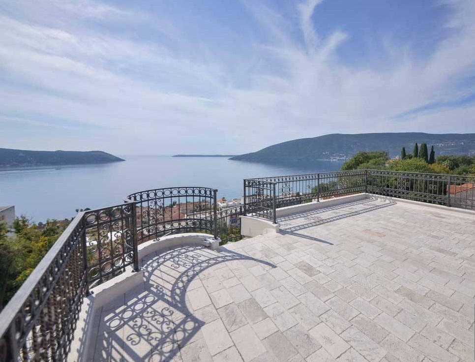 Spacious terrace with wrought-iron railing and panoramic views of the sea and mountains, villa in Herceg Novi, Montenegro.