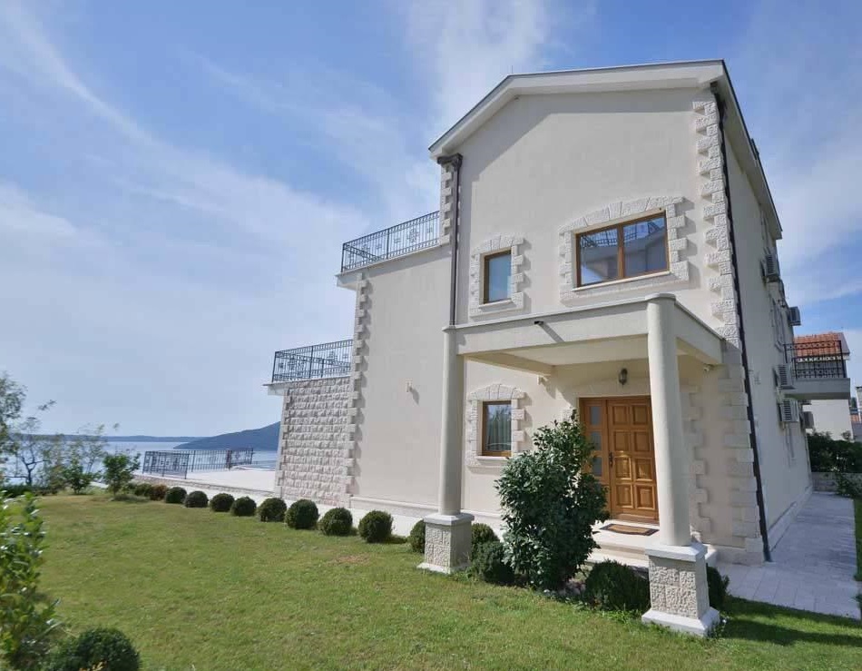 Two-story villa with terraces and sea views in Herceg Novi, Montenegro: stone facade and a well-kept garden.