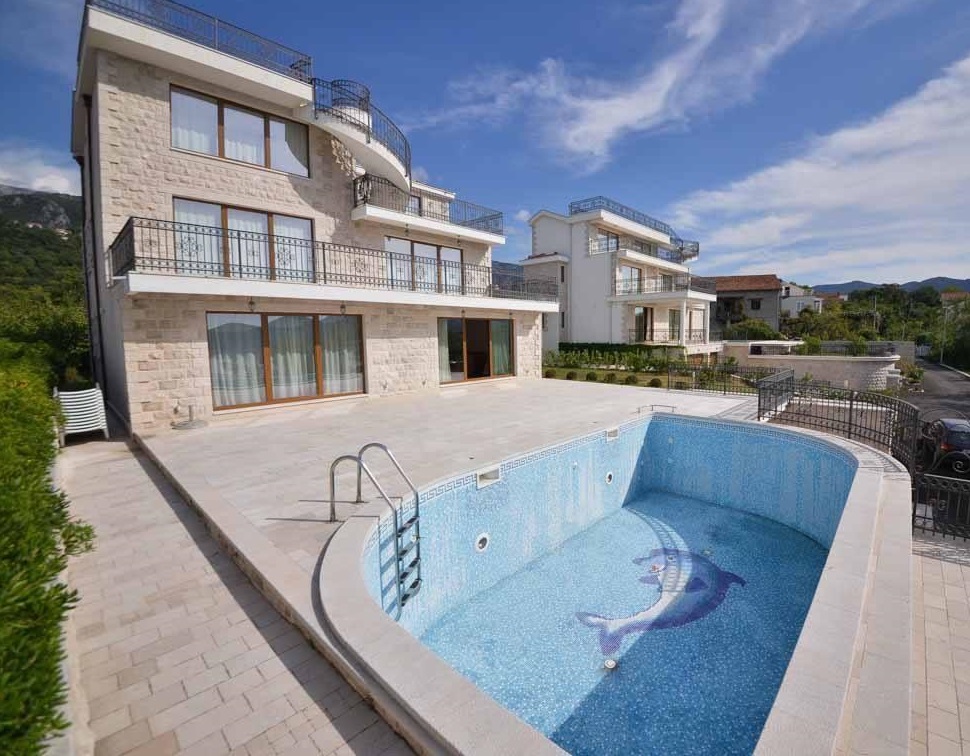 Three-story villa in Herceg Novi, Montenegro, with an outdoor pool, stone facade, and terrace.