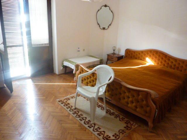 Bedroom with a double bed, parquet flooring, and access to the terrace in a house, Kumbor, Montenegro.