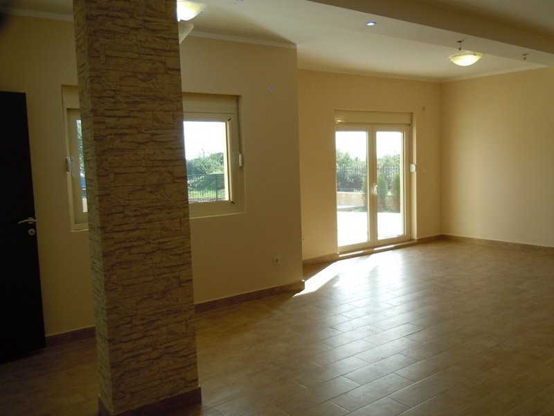 Bright living room with stone finishes and access to the terrace in a house, Budva, Montenegro.