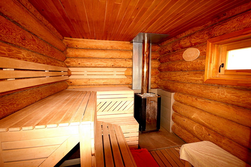 Interior of a wooden sauna with benches and a stove in a house for sale in Sutomore, Montenegro.