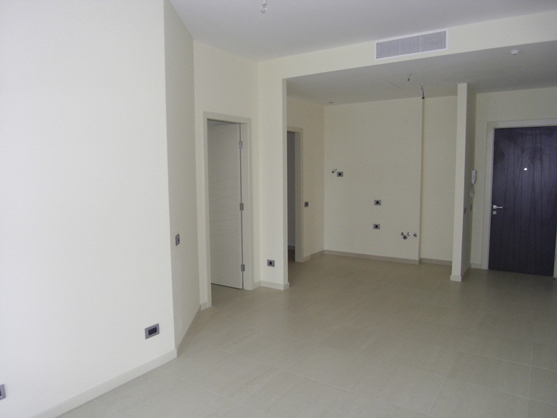 Bright living room in a new building in Budva, Montenegro: finished interior, tiled floor, interior doors, and air conditioning.