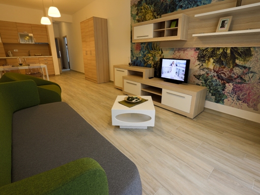 Living room with modern furniture and kitchen in an apartment, Dobri Vody, Montenegro. Bright interior with an accent wall.