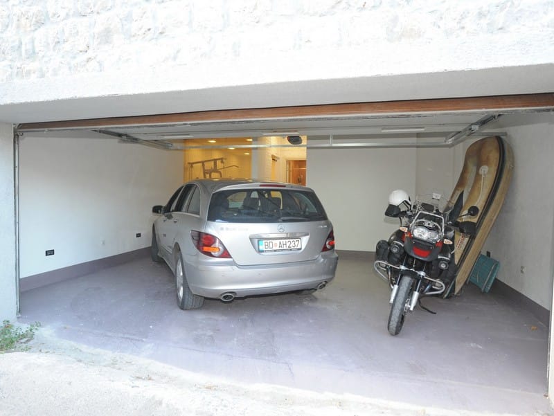 Spacious garage at a villa in Bigovo, Montenegro, with space for a car, motorcycle, and sports equipment.
