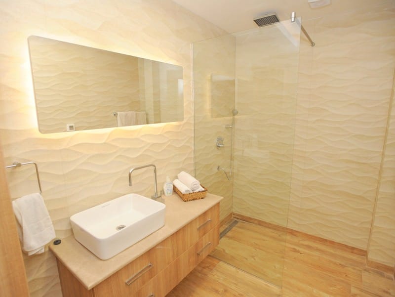 Modern bathroom with a shower cabin and mirror lighting in a villa in Bigovo, Montenegro.
