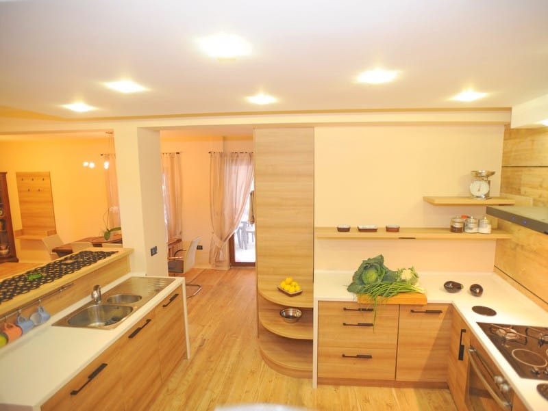 Modern kitchen with wooden furniture and built-in appliances in a villa in Bigovo, Montenegro.