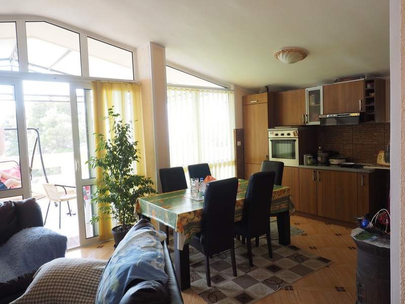 Kitchen-dining room with wooden cabinetry and access to the terrace in a house, Bar, Montenegro.