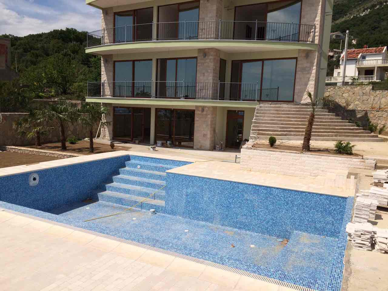 Modern villa in Shushan, Montenegro, with an outdoor pool, panoramic windows, and a stone facade finish.