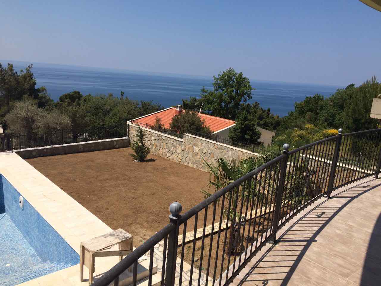 View from the villa terrace in Shushan, Montenegro: private pool, garden plot, and panoramic view of the Adriatic Sea.