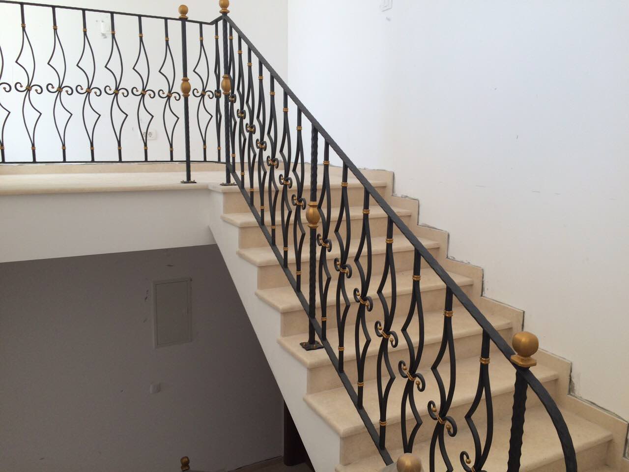 Stone staircase with wrought-iron railings in the interior of a villa in Shushan, Montenegro. Stylish home finishes.