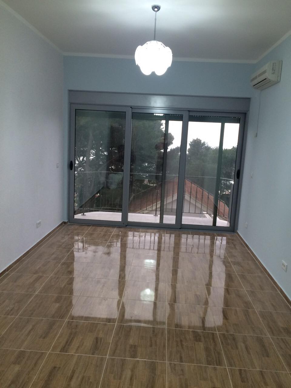 Bright living room with a panoramic window and access to the balcony in a house, Shushan, Montenegro. Tiled floor, air conditioning.
