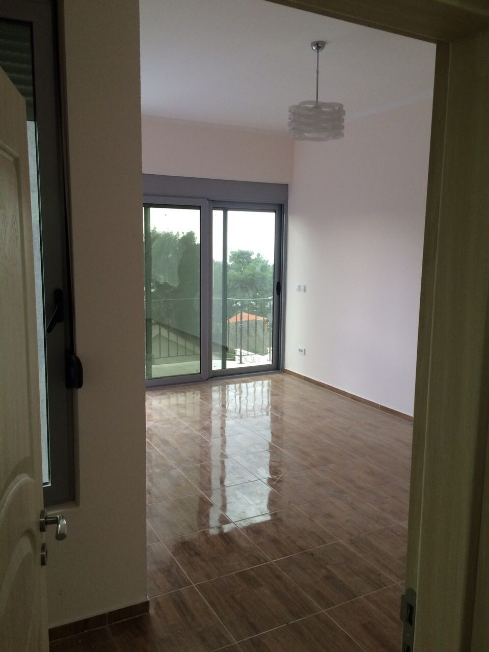 Bright living room with panoramic access to the terrace in a house, Shushan, Montenegro: tiled floor and modern design.