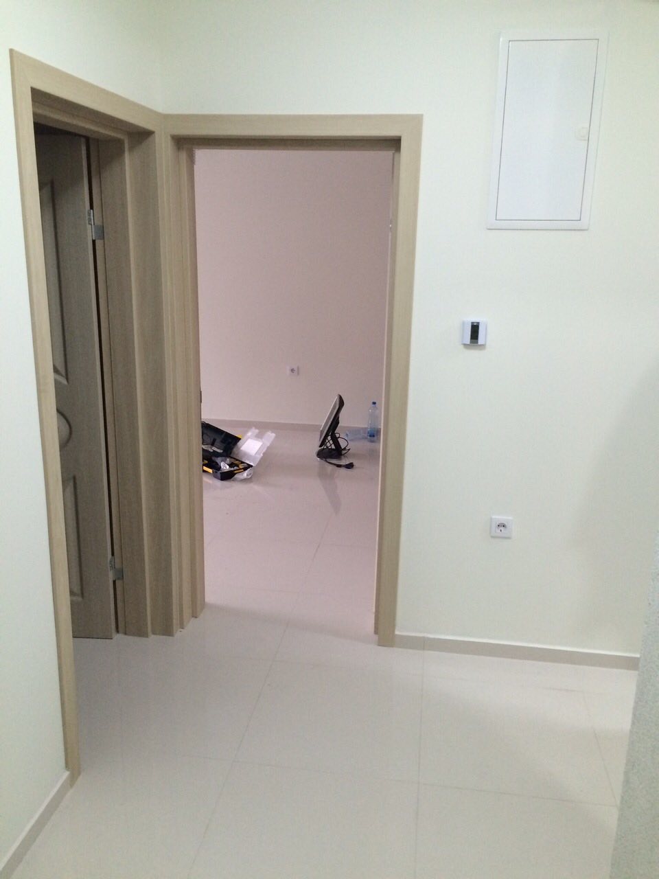 Bright interior of a house in Shushan, Montenegro: interior doors, light floor tiles, and an empty room after renovation.