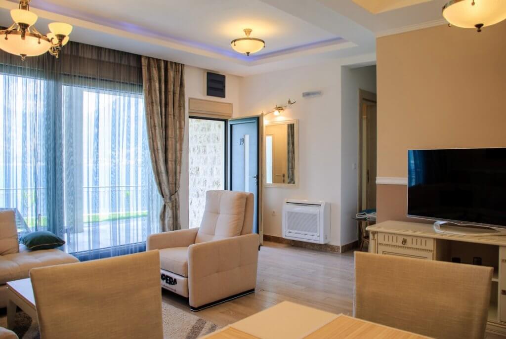 Cozy living room with soft furniture and access to the terrace in an apartment, Kostanica, Montenegro.