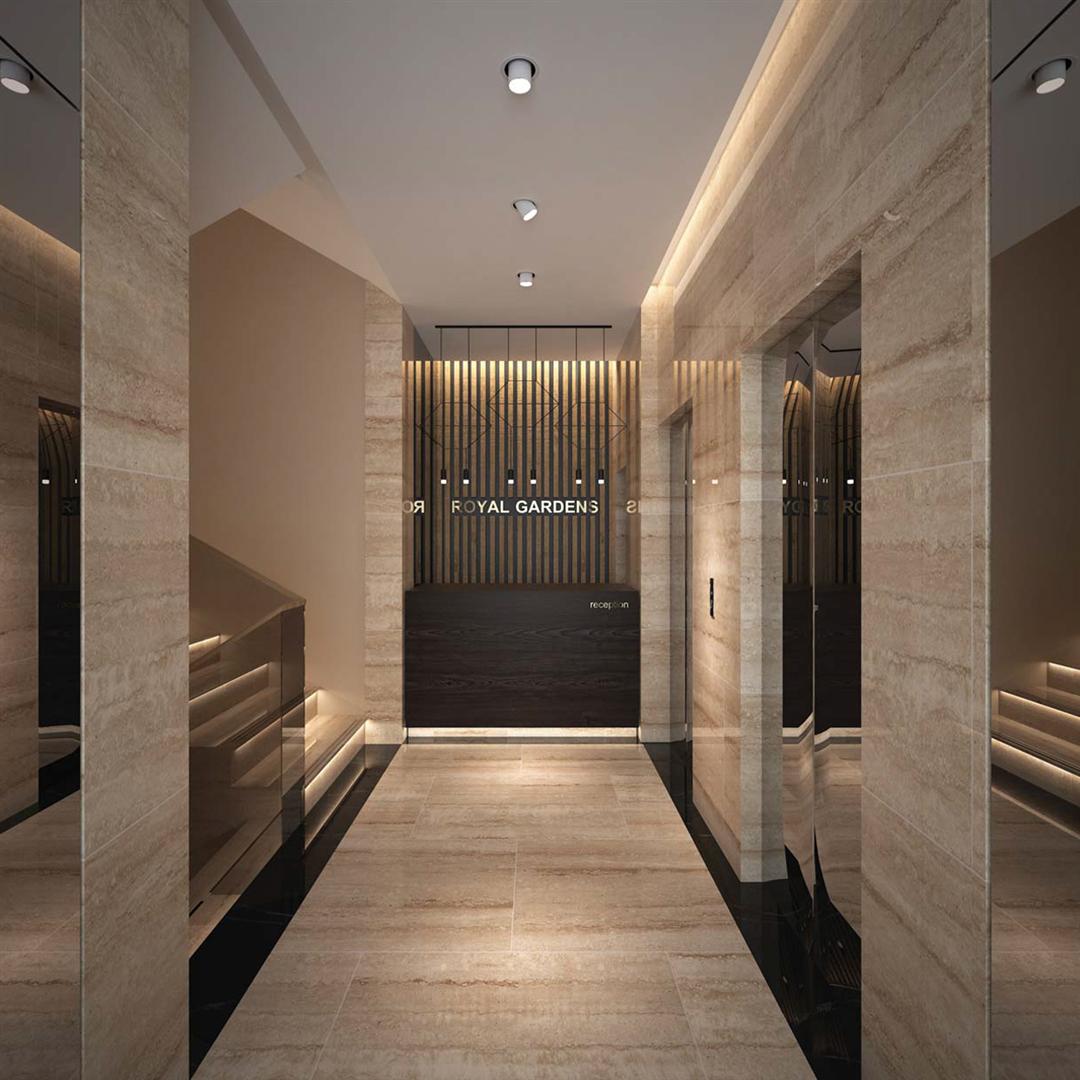 Modern reception desk in Royal Gardens residential complex, Budva, Montenegro: travertine finish, stylish lighting, and elevator.