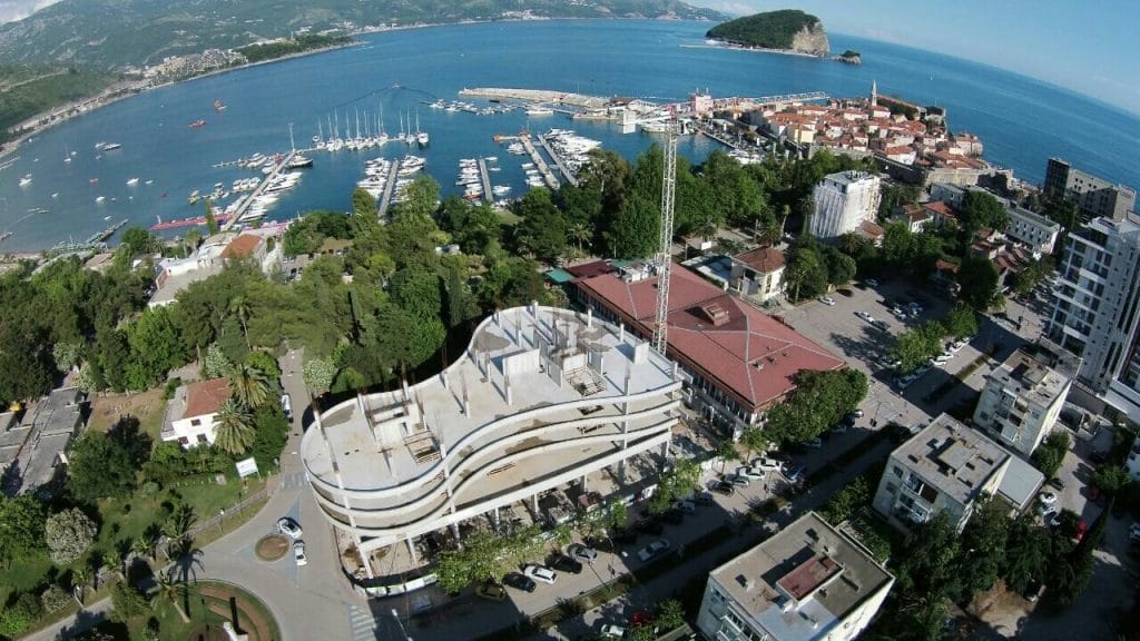 Residential complex under construction in Budva, Montenegro: aerial view of the seaside development and the Old Town marina.