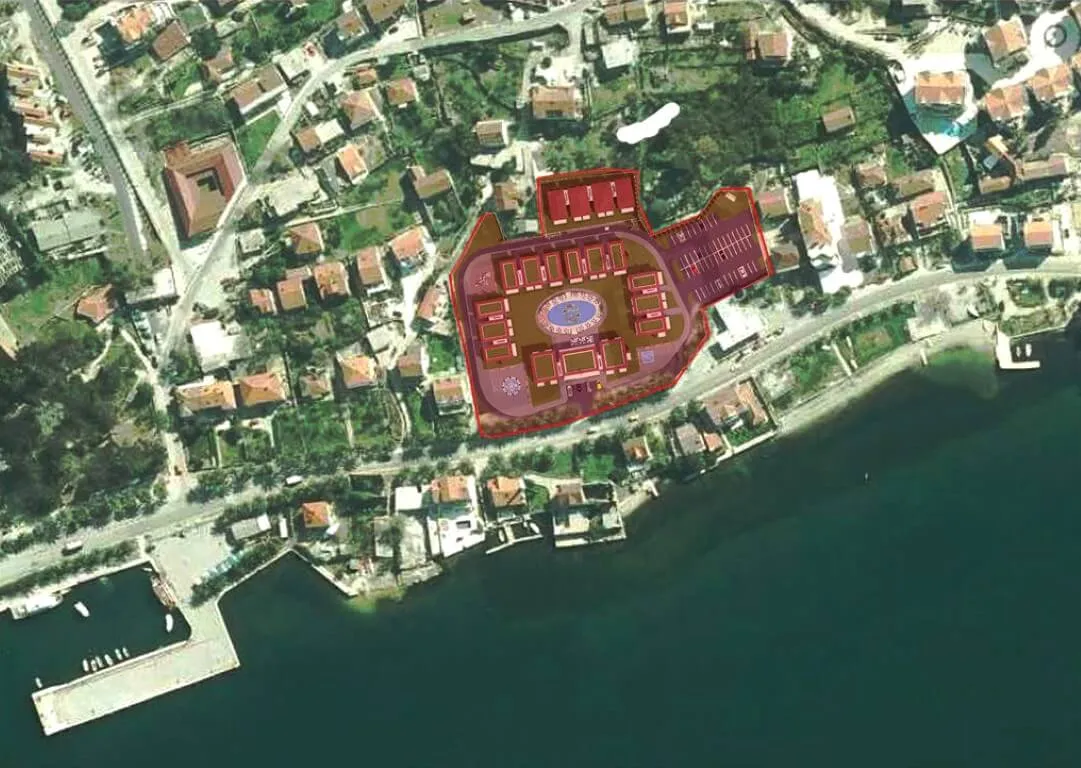Satellite site plan of a coastal development showing buildings, parking, and a central pool.