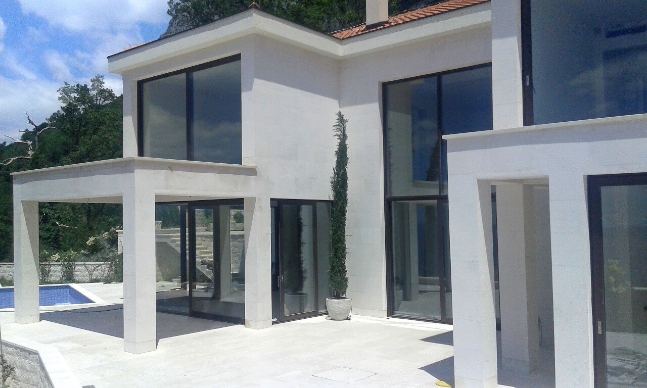 Modern villa with panoramic windows, a terrace and a pool in Reževići, Montenegro: front view of the house.
