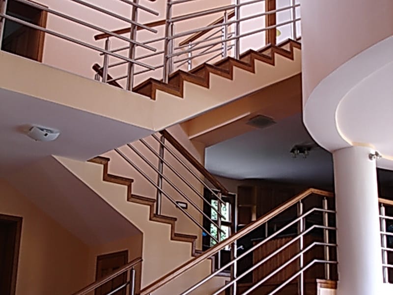 Modern staircase with wooden steps and metal railings in a villa interior, Utjeha, Montenegro.