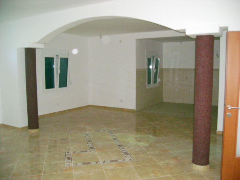 Spacious living room with decorative columns and tiled floor in a villa, Bar, Montenegro.