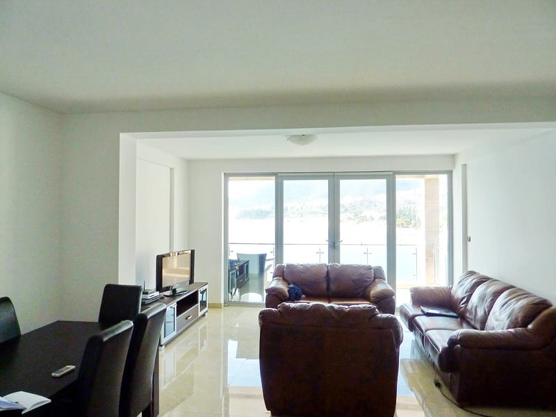 Living room with leather furniture and panoramic sea view in an apartment, Rafailovici, Montenegro.