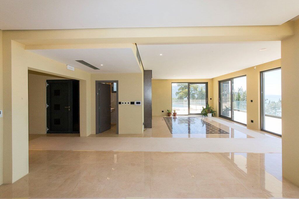 Spacious living room with panoramic windows and sea view in a modern villa, Budva, Montenegro.