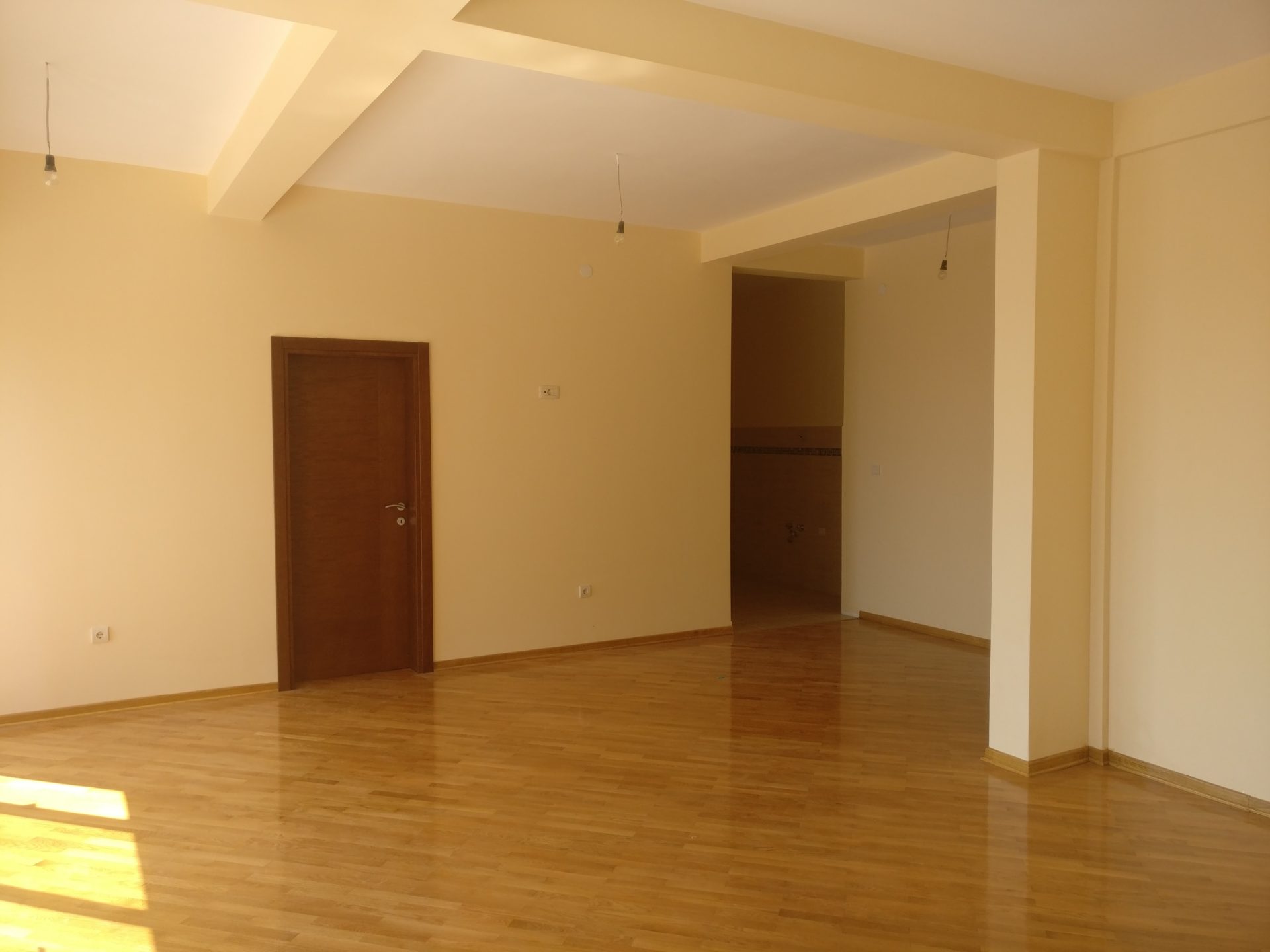 Spacious living room with parquet flooring and light walls in a house for sale, Shushan, Montenegro.