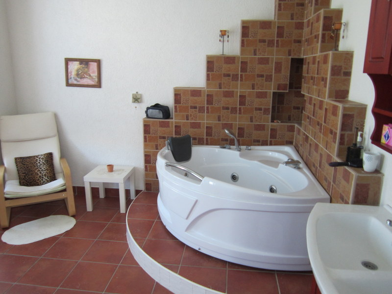Bathroom with corner jacuzzi and tiled finish in a house for sale, Utjeha, Montenegro.