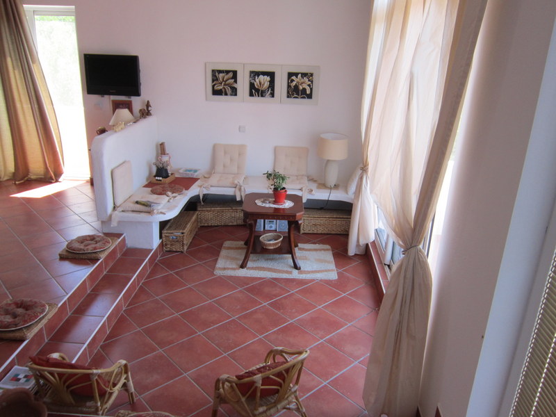 Cozy living room with terracotta flooring and built-in furniture in a house for sale in Utjeha, Montenegro.