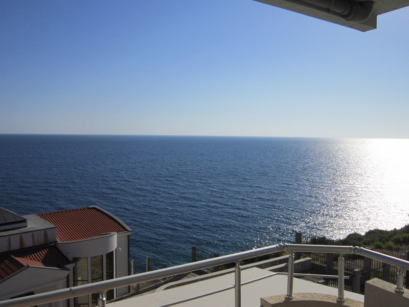 Panoramic view of the Adriatic Sea from the balcony of a house in Utjeha, Montenegro: terrace with a metal railing.