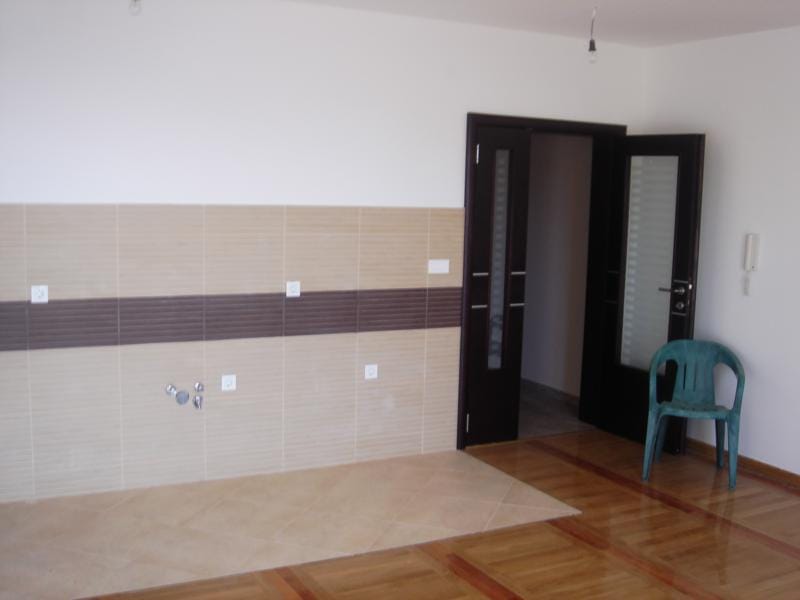 Kitchen in an apartment in Miločer, Montenegro: backsplash area with tile, parquet floor, and a dark interior door.