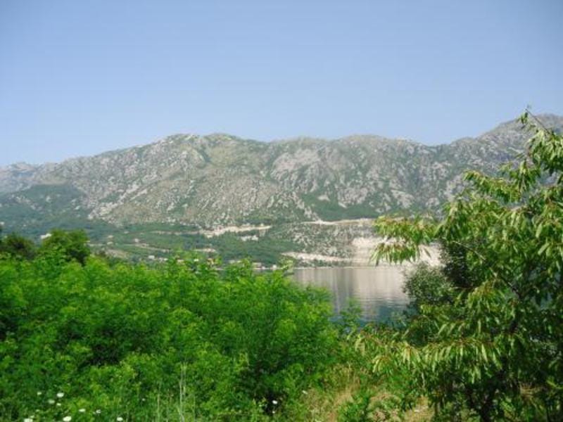 Panoramic view of the mountains and Kotor Bay from a plot of land in Kostanjica, Montenegro.