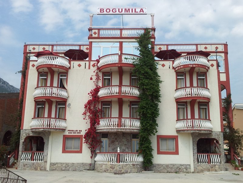 Facade of the Bogumila hotel in Bar, Montenegro: a four-story building with balconies, a terrace, and decorative elements.