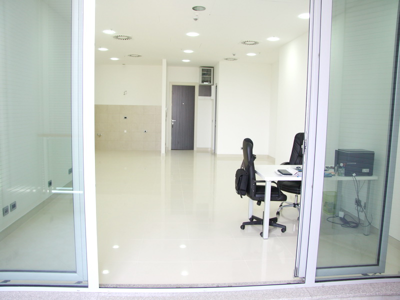 Bright office interior with panoramic windows and furniture for rent in Budva, Montenegro. Modern commercial space.