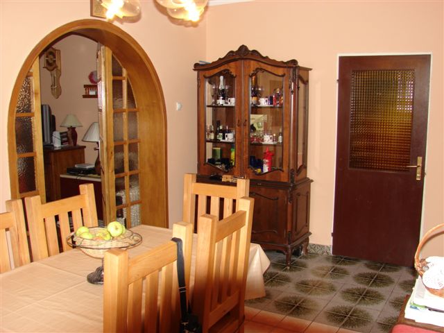 Living room interior with wooden furniture and an arched passage in a house for sale in Budva, Montenegro.